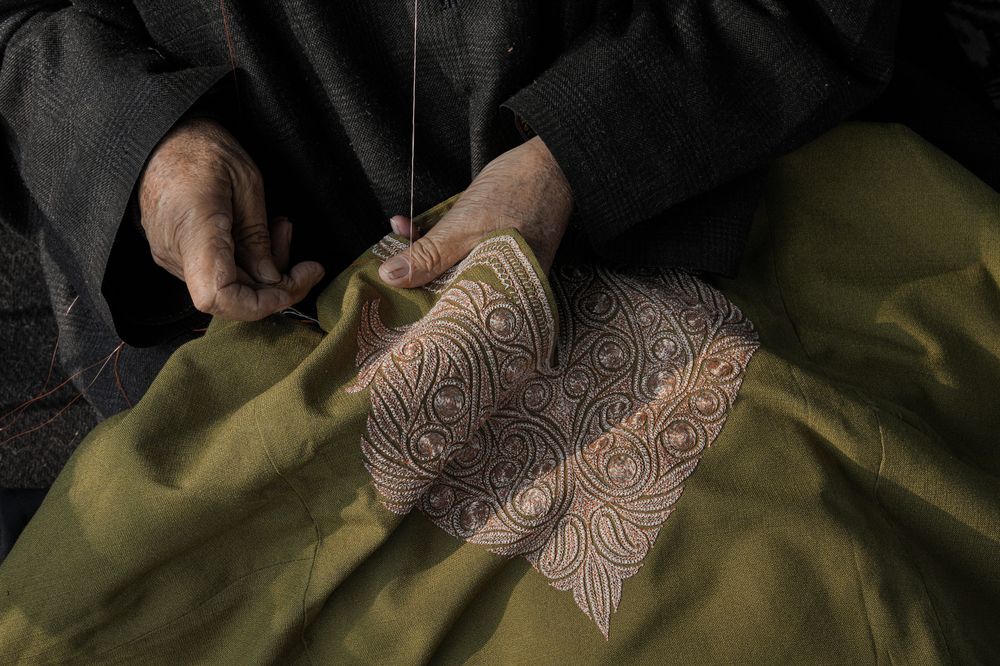 Artisan hand-embroidering Sozni work on a Kashmiri shawl